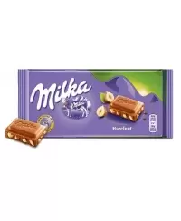 Šokoladas MILKA, su skaldytais lazdyno riešutais, 100 g
